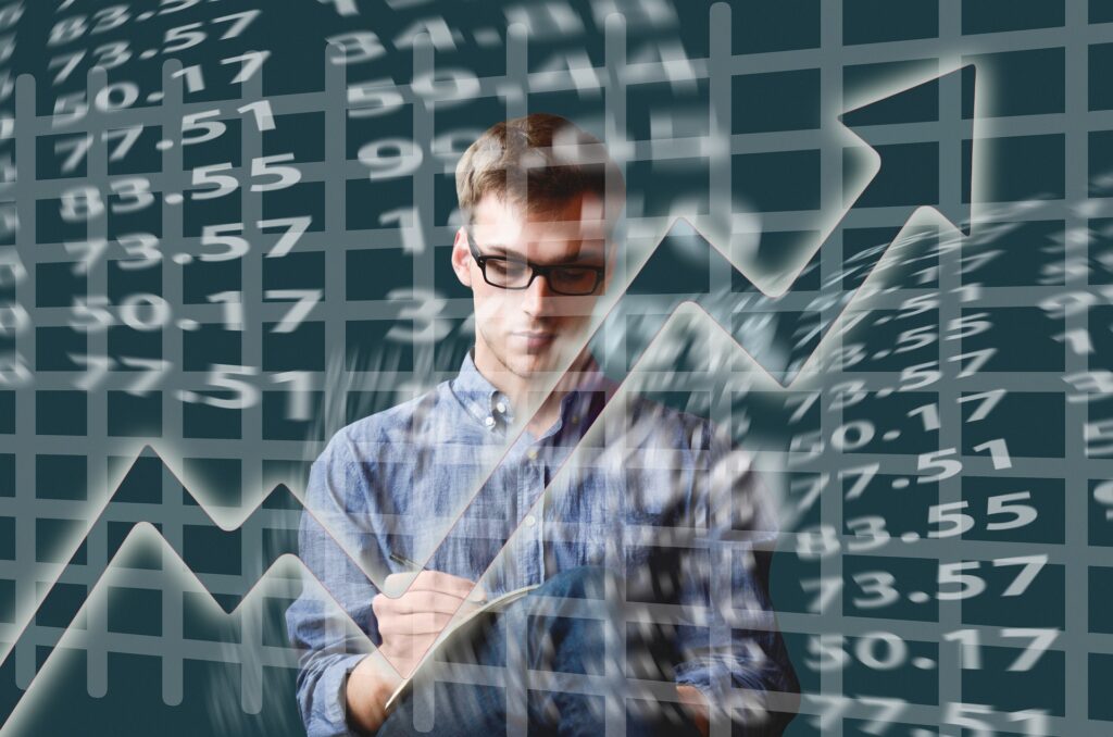 A trader observing market trends on a screen with financial data.